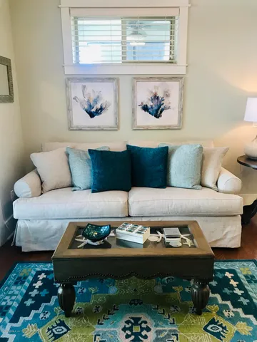 a living room with furniture and a rug