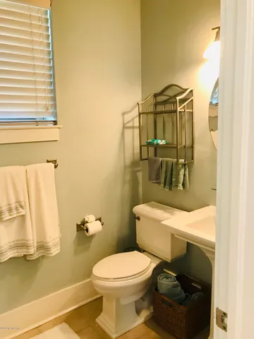 a white toilet sitting next to a bathroom sink