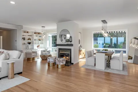 a living room with furniture a fireplace and a chandelier