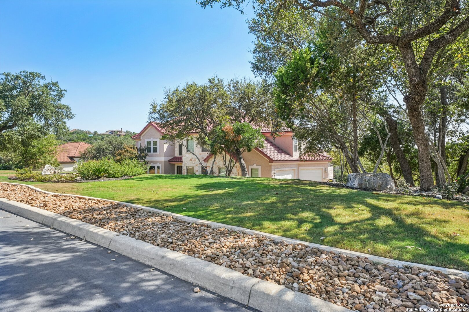 718 Ruidosa Downs Helotes, TX 78023 - Photo 44 of 50 a front view of a house with a yard and large trees