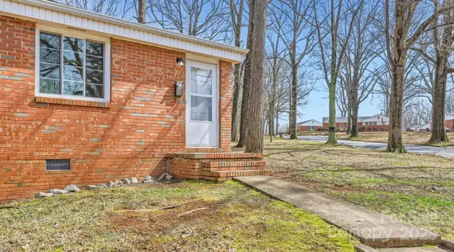 a view of a brick house with a yard