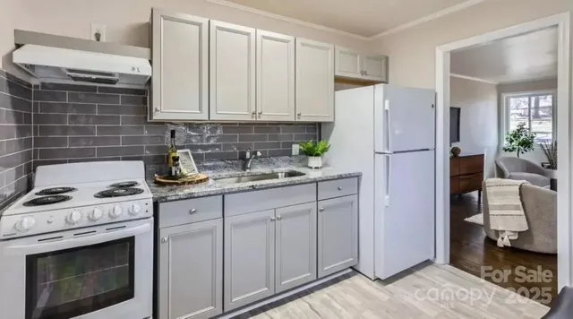 a kitchen with white cabinets and white appliances