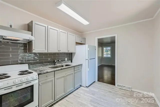 a kitchen with a sink stove and cabinets