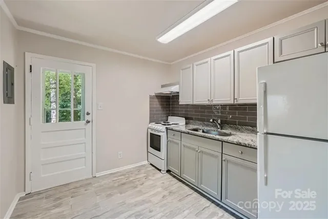 a kitchen with white cabinets and white appliances
