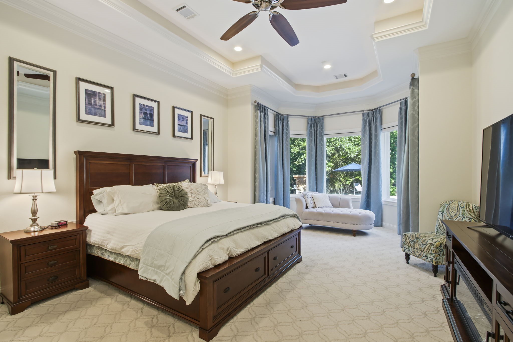 36702 Deer Valley Magnolia, TX 77355 - Photo 20 of 46 a spacious bedroom with a large bed and a chandelier