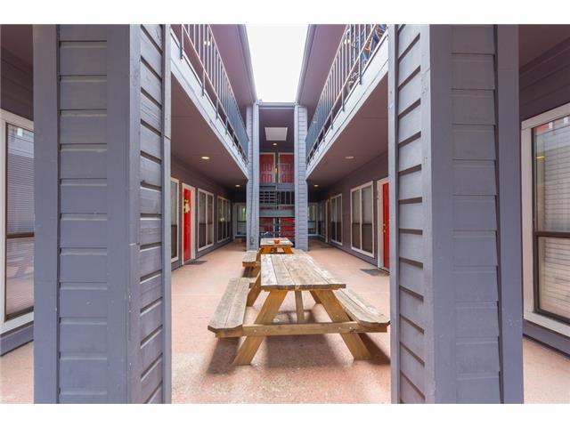 2804 Rio Grande Street, Unit 204 Austin, TX 78705 - Photo 2 of 12 A welcoming courtyard with outdoor seating provides a communal gathering space for residents.