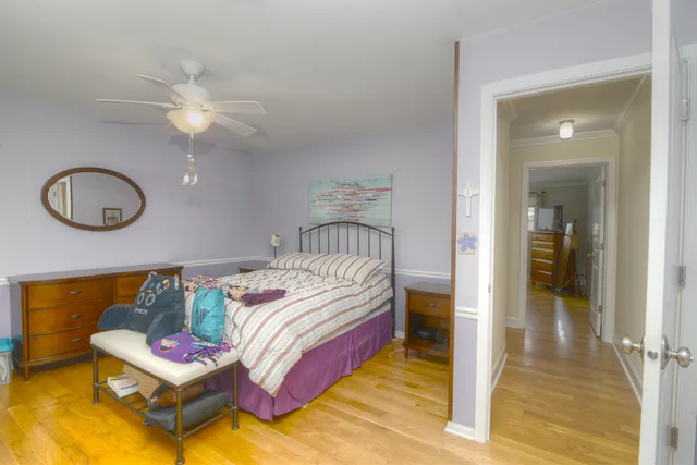 a bedroom with bed and a mirror