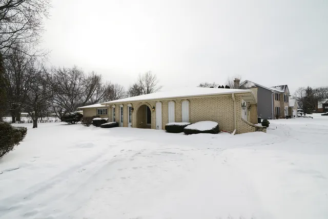 a view of a house with a snow in the yard