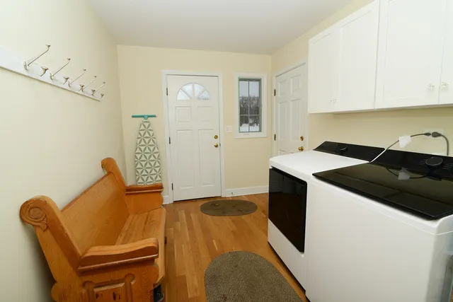 a kitchen with a table chairs and a refrigerator