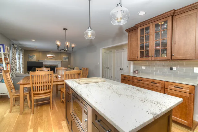 a kitchen with a table chairs and white cabinets