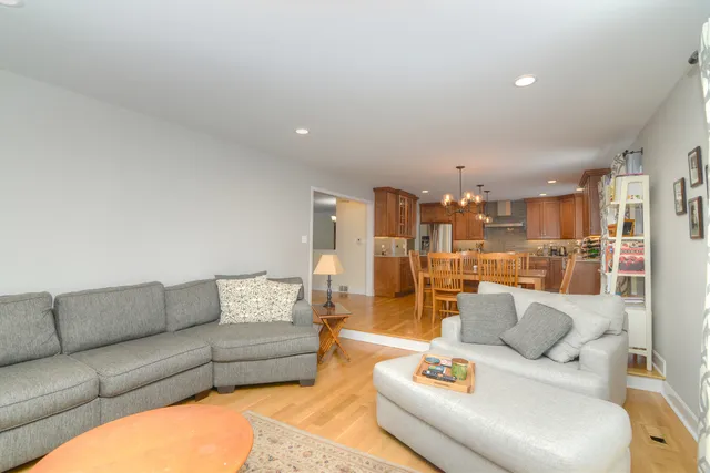 a living room with furniture and a view of kitchen