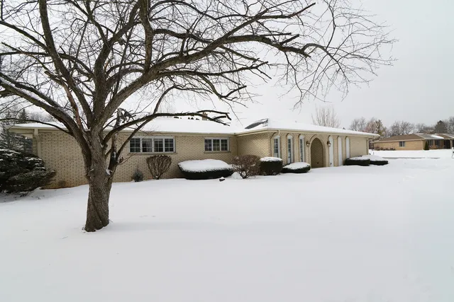 a view of a house with a snow in the yard