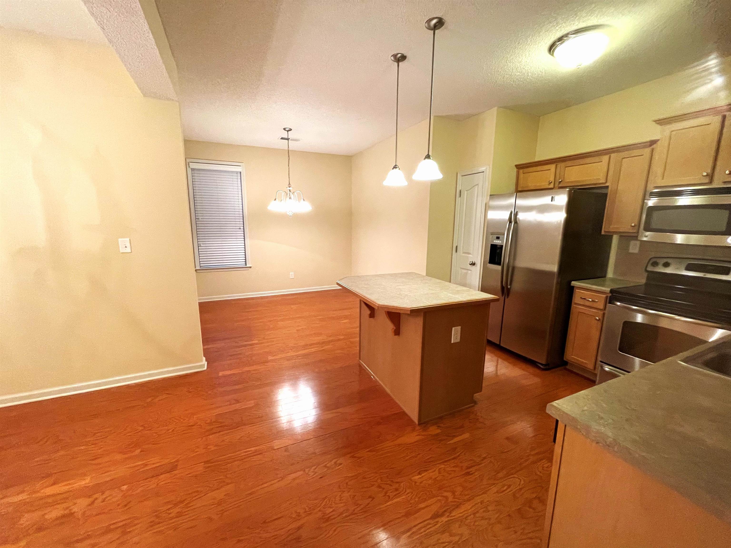 4965 Shaws Ridge Trail Arlington, TN 38002 - Photo 4 of 19 a large kitchen with stainless steel appliances kitchen island a large counter top and wooden floors