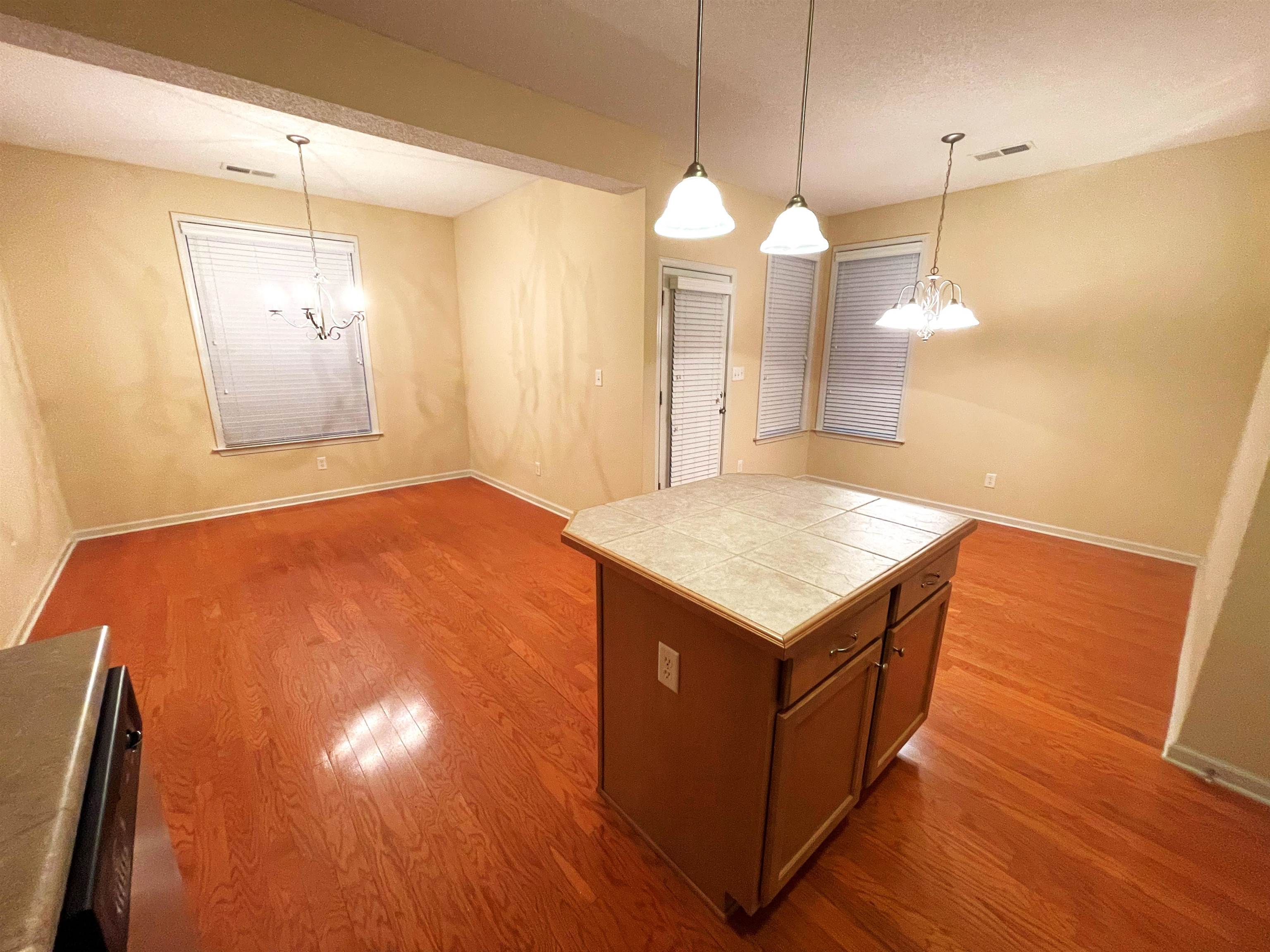 4965 Shaws Ridge Trail Arlington, TN 38002 - Photo 5 of 19 a kitchen with a wooden floor and a chandelier