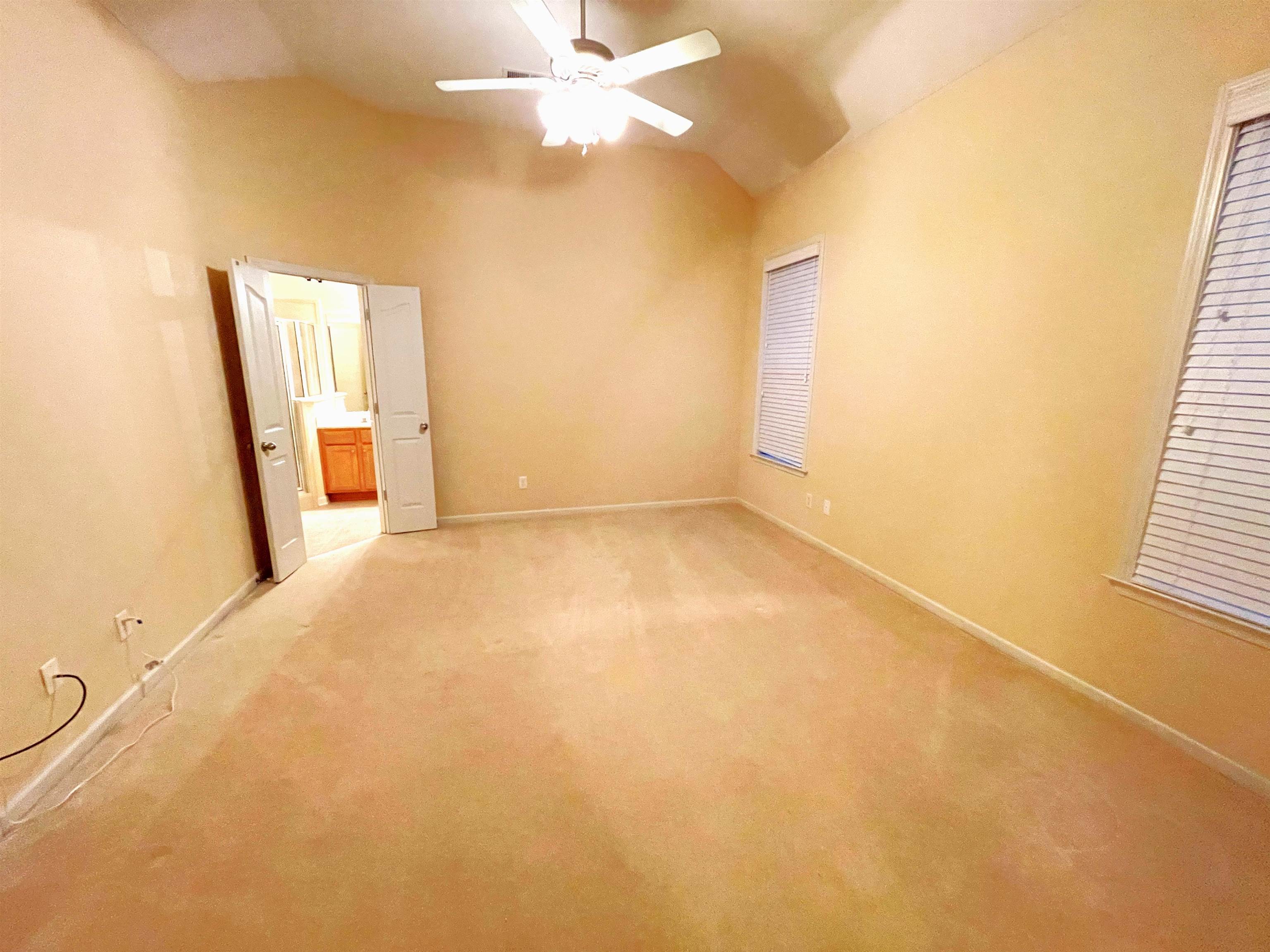 4965 Shaws Ridge Trail Arlington, TN 38002 - Photo 7 of 19 an empty room with a chandelier fan and windows