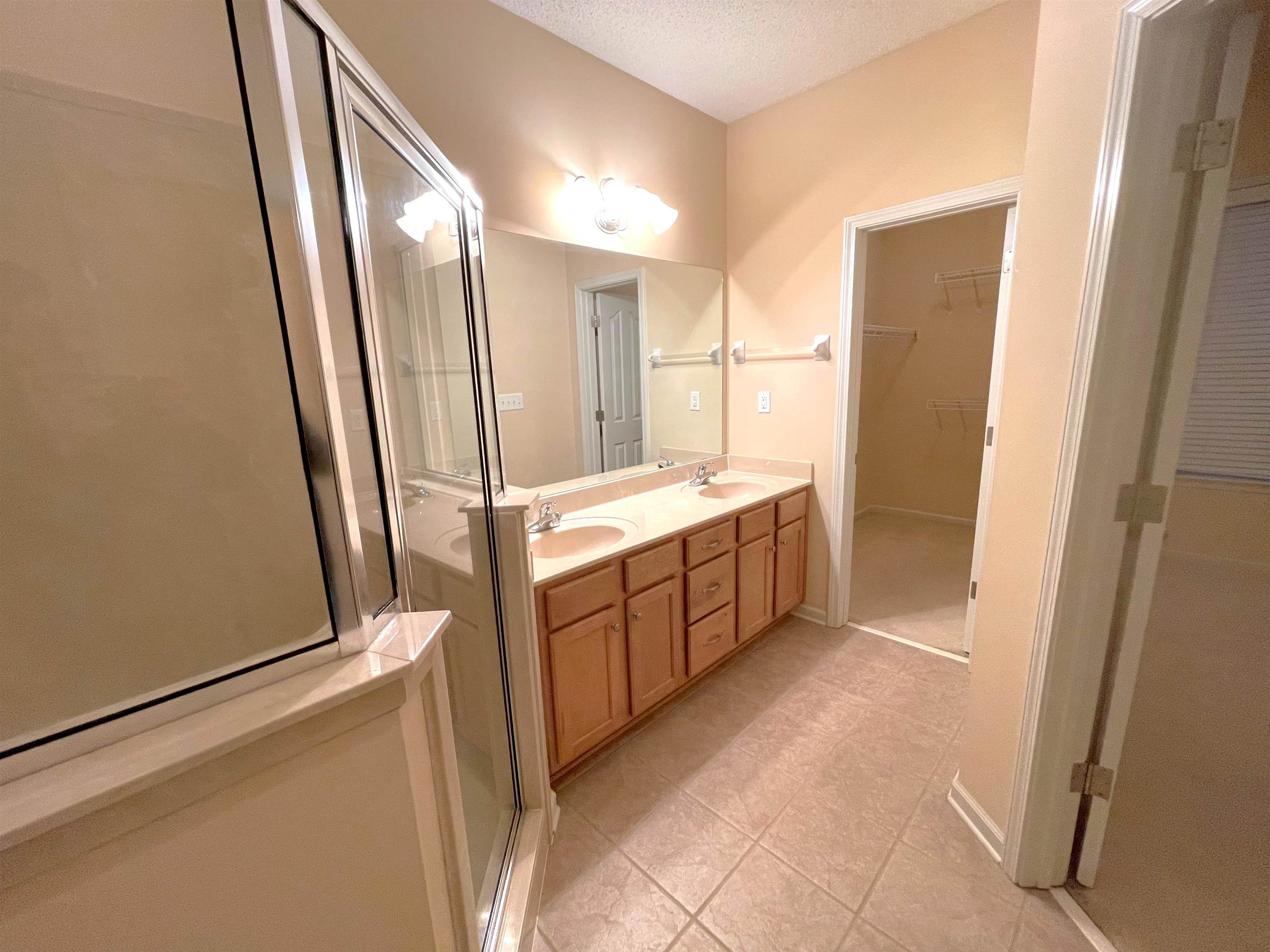 4965 Shaws Ridge Trail Arlington, TN 38002 - Photo 8 of 19 a bathroom with a double vanity sink a mirror and a bathtub