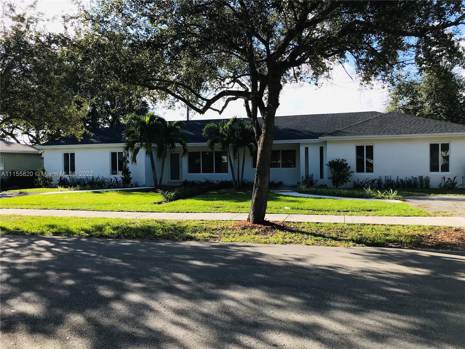 a view of a house with swimming pool and a yard