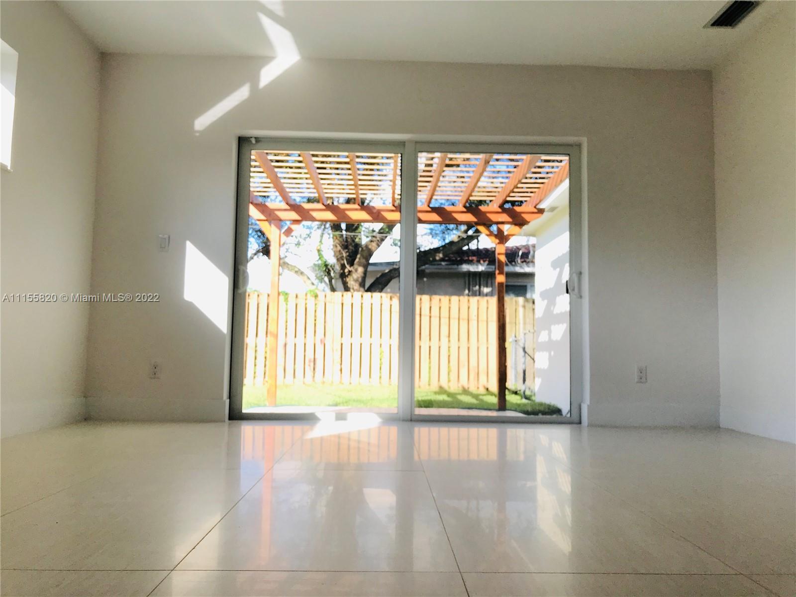 11720 Southwest 81st Road, Unit 11720 Pinecrest, FL 33156 - Photo 12 of 33 a view of an empty room with a window