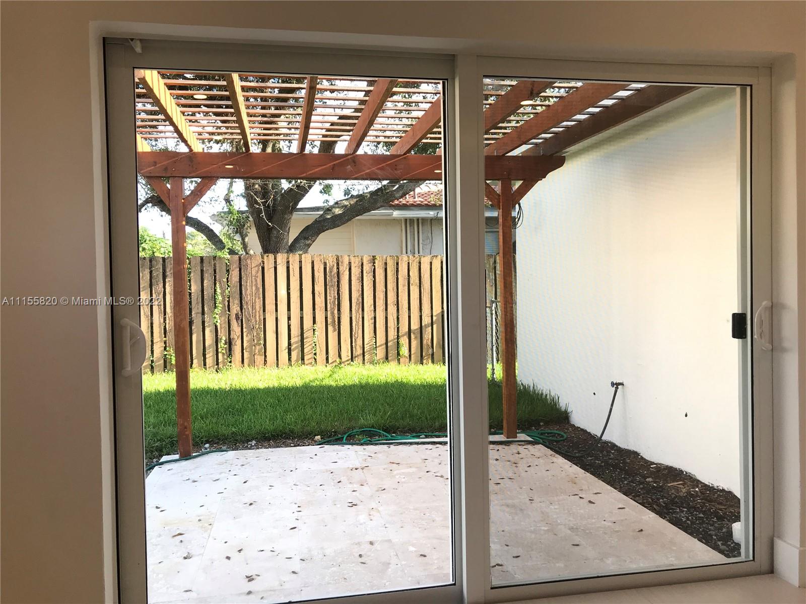 11720 Southwest 81st Road, Unit 11720 Pinecrest, FL 33156 - Photo 16 of 33 a view of a porch with a door