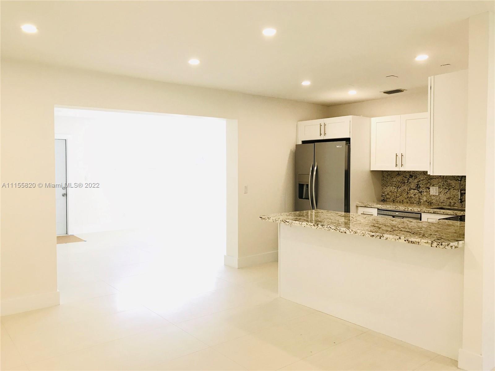 11720 Southwest 81st Road, Unit 11720 Pinecrest, FL 33156 - Photo 2 of 33 a large kitchen with stainless steel appliances a refrigerator and a stove