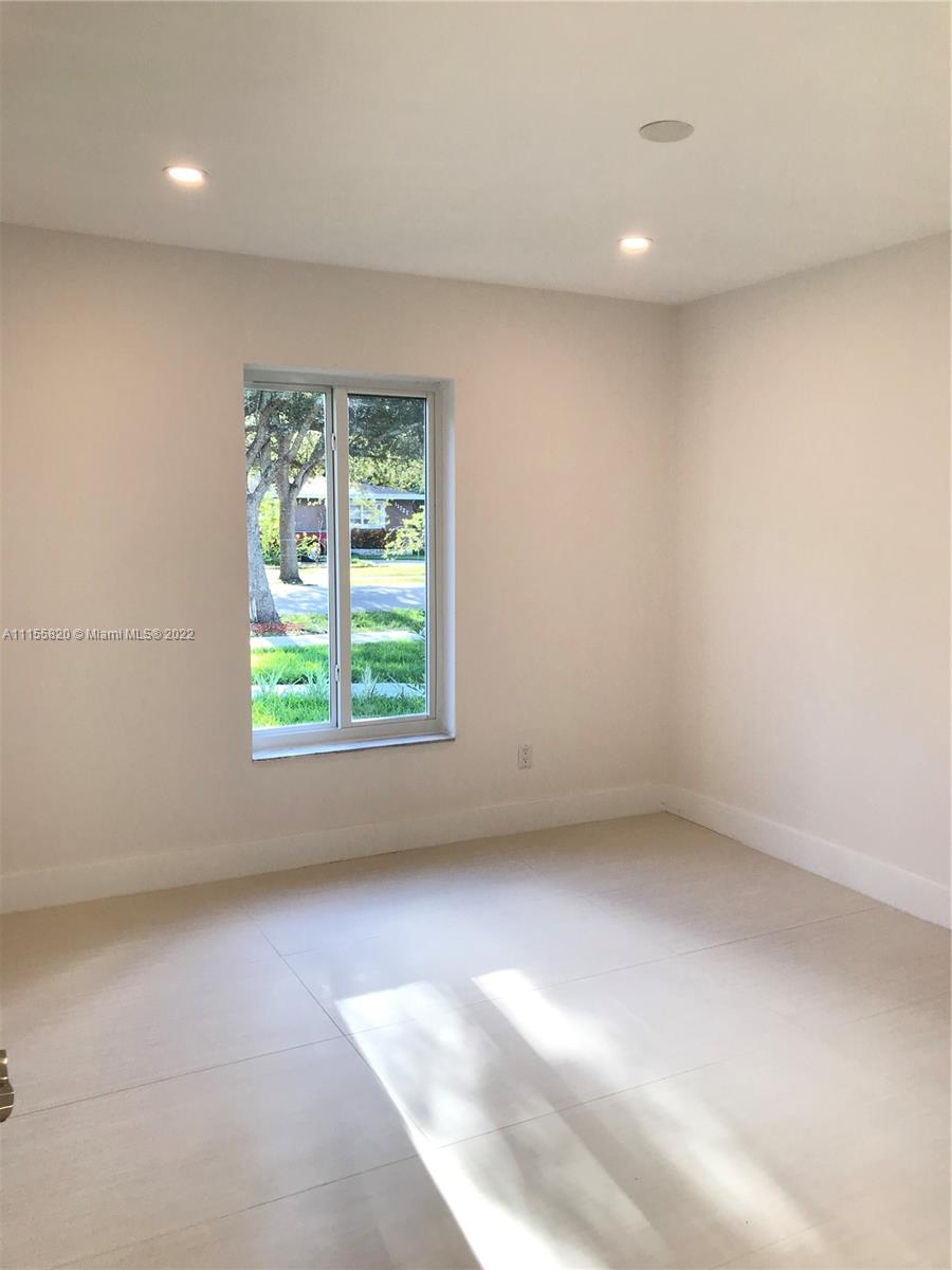 11720 Southwest 81st Road, Unit 11720 Pinecrest, FL 33156 - Photo 21 of 33 an empty room with a window