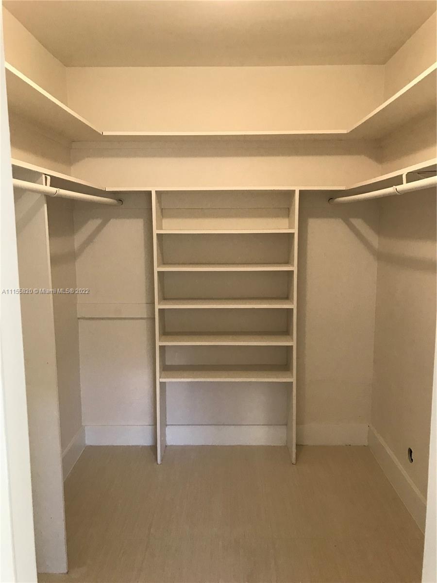 11720 Southwest 81st Road, Unit 11720 Pinecrest, FL 33156 - Photo 23 of 33 a view of walk in closet with empty racks