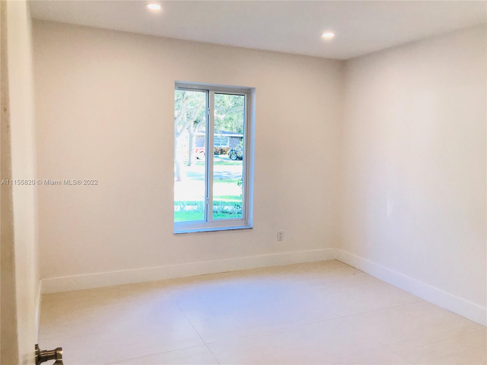 11720 Southwest 81st Road, Unit 11720 Pinecrest, FL 33156 - Photo 6 of 33 an empty room with a window