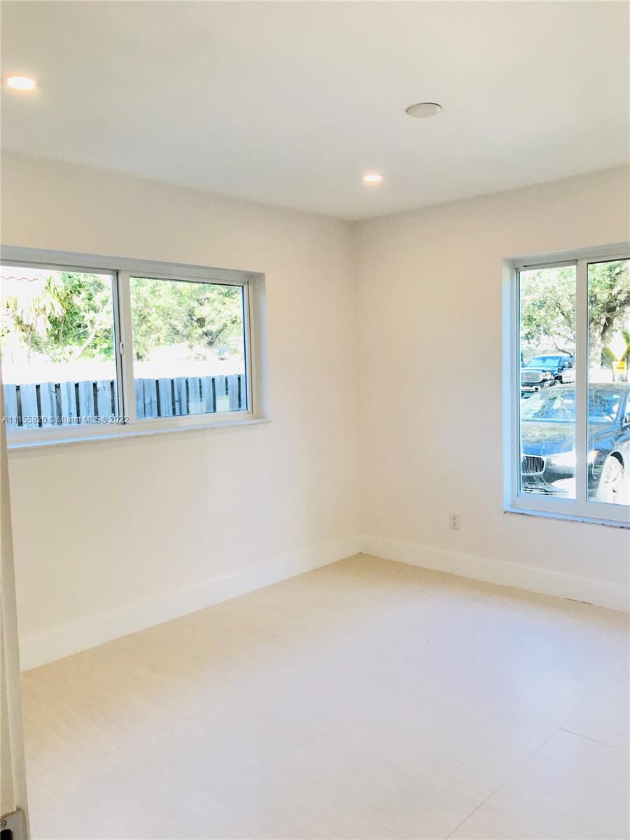 11720 Southwest 81st Road, Unit 11720 Pinecrest, FL 33156 - Photo 7 of 33 an empty room with a window