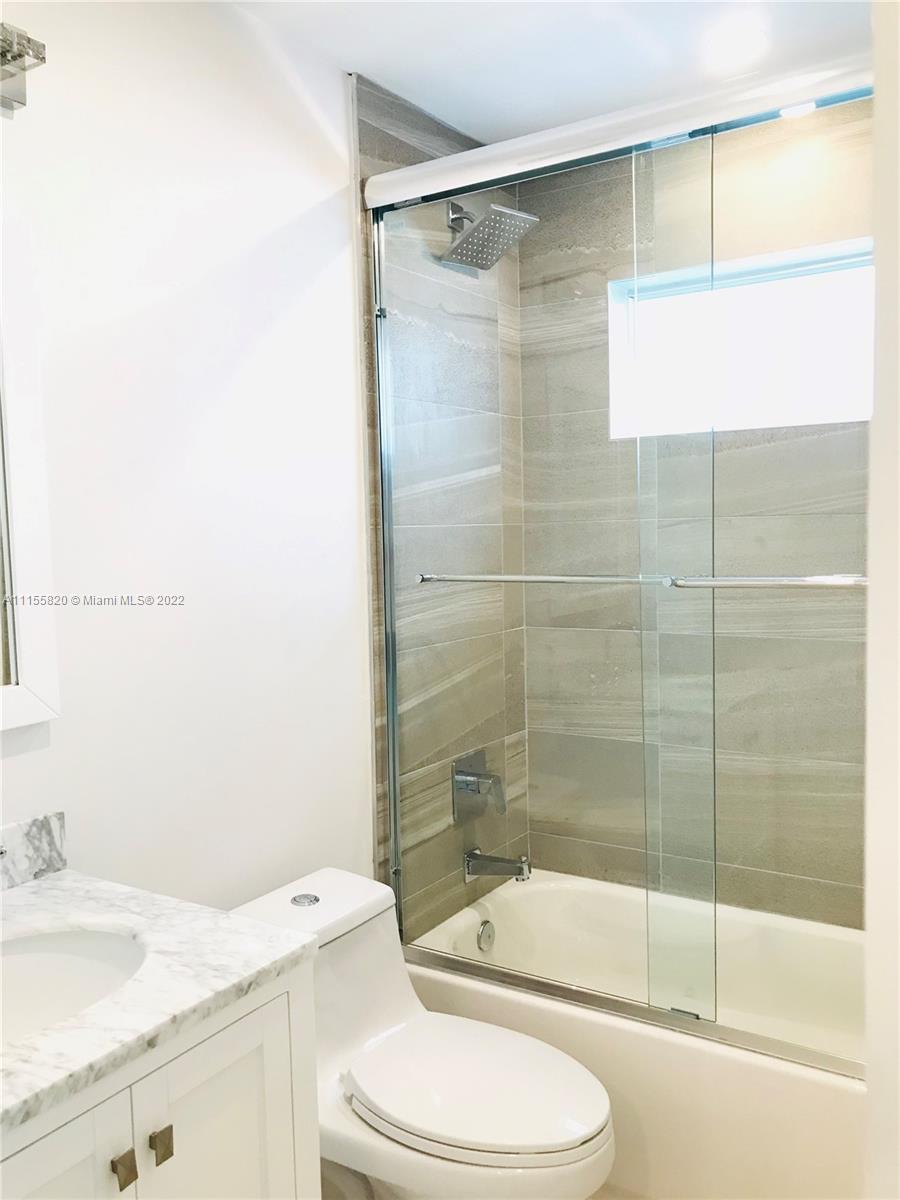 11720 Southwest 81st Road, Unit 11720 Pinecrest, FL 33156 - Photo 8 of 33 a bathroom with a granite countertop bathtub shower sink vanity and toilet