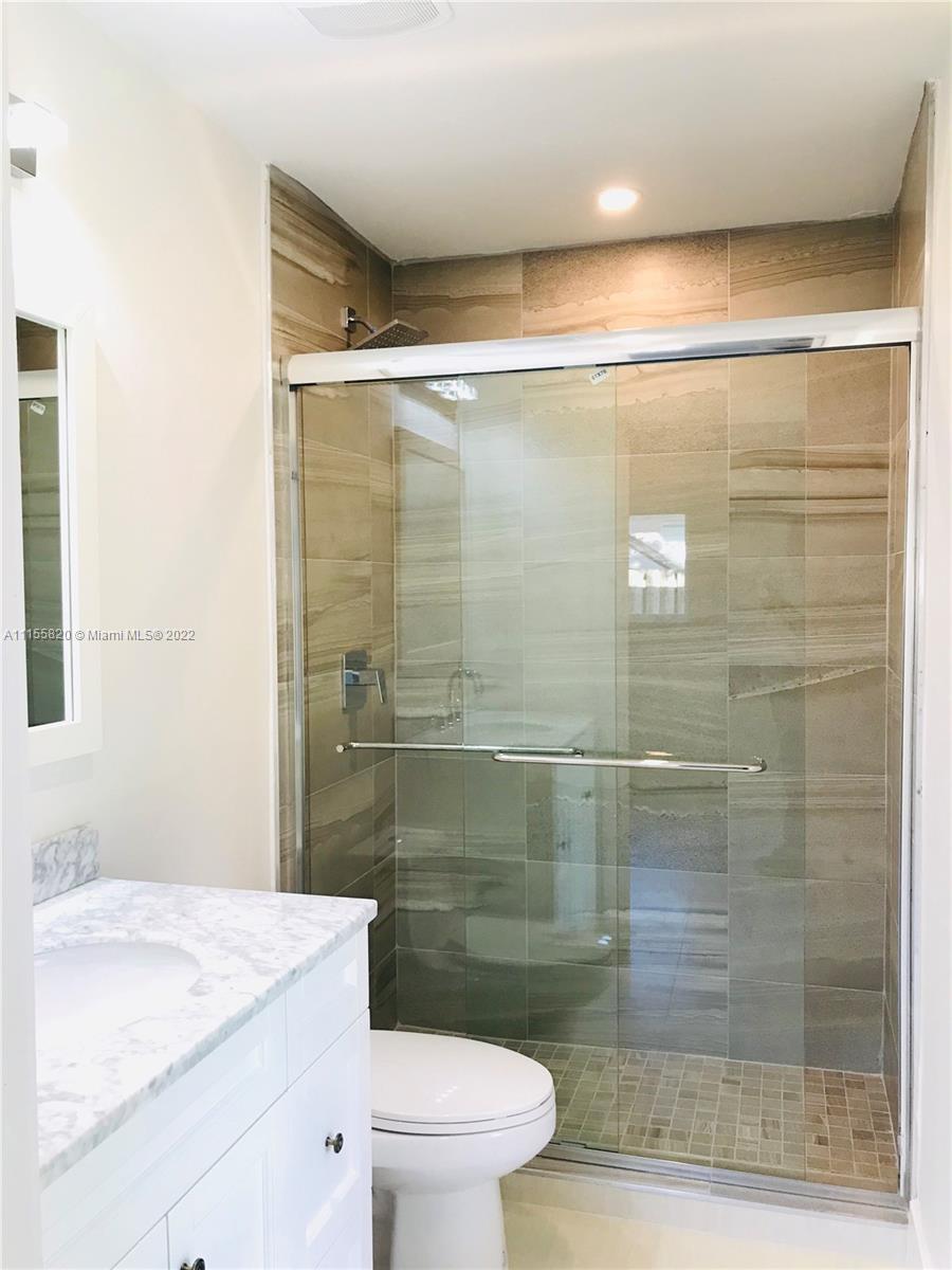 11720 Southwest 81st Road, Unit 11720 Pinecrest, FL 33156 - Photo 9 of 33 a bathroom with a shower a toilet and a sink