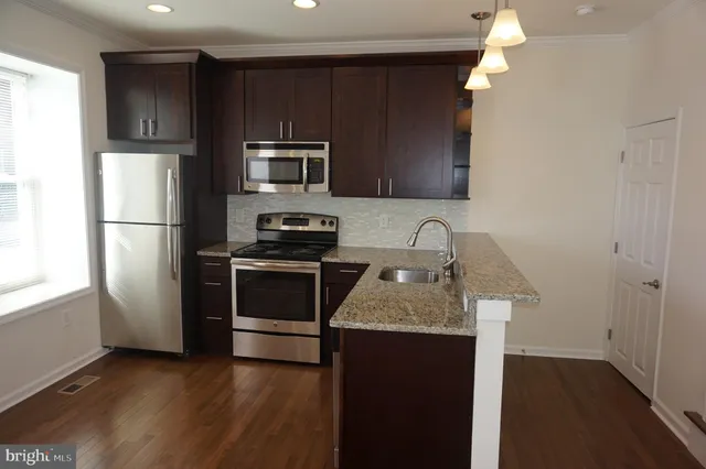 a kitchen with a refrigerator sink and microwave