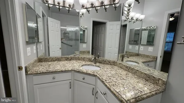 an empty room with closet and chandelier fan