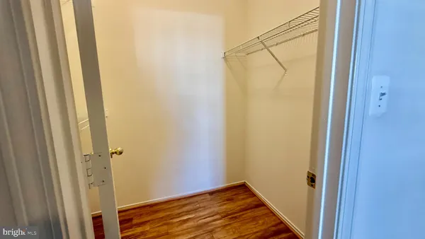 an empty room with closet and windows