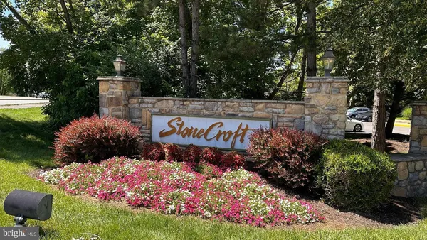 a sign that is in front of flowers