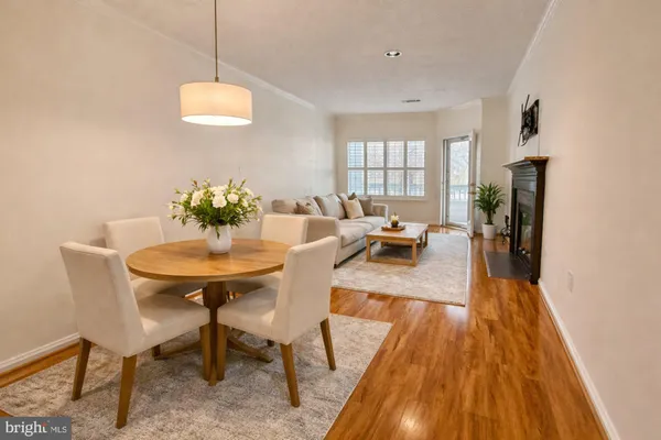 a view of a livingroom with wooden floor and a fireplace
