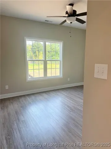 a bathroom with a granite countertop sink a toilet and a mirror