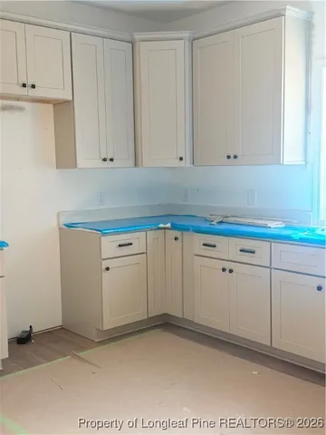 a kitchen with granite countertop a stove and a sink