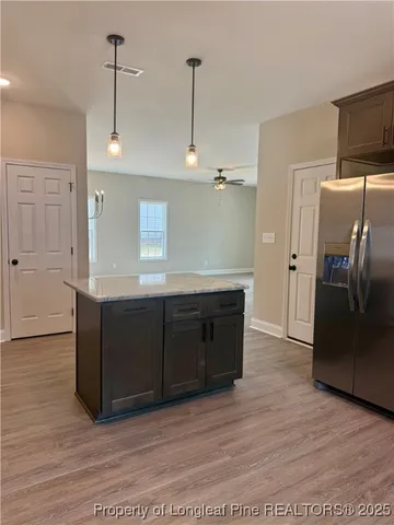a kitchen with a refrigerator stove and cabinets