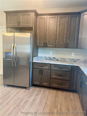 a kitchen with granite countertop a stove and a microwave