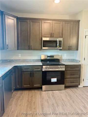 a kitchen with granite countertop a stove and a sink