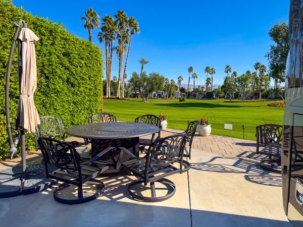 a view of a chairs and table on the patio