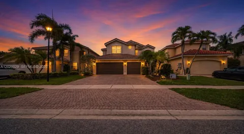 a front view of a house with a yard and a garage