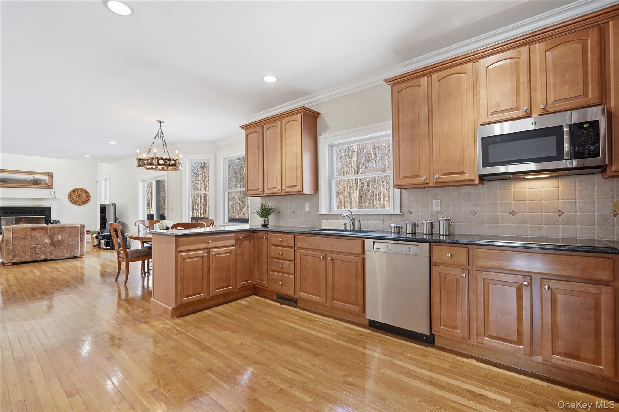 127 Smith Ridge Road South Salem, NY 10590 - Photo 17 of 49 a kitchen with stainless steel appliances granite countertop a stove a sink dishwasher a microwave oven with cabinets and wooden floor