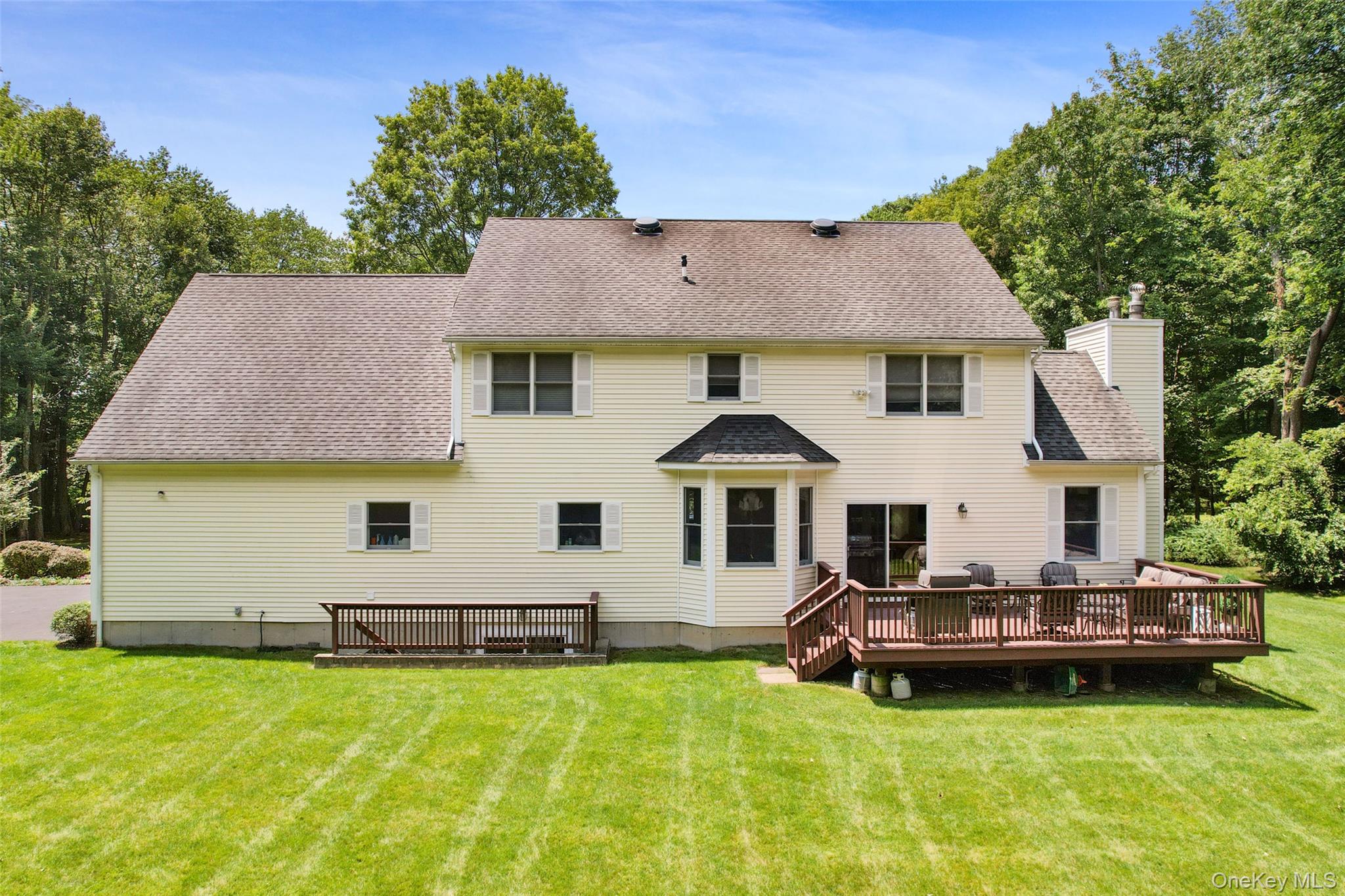 127 Smith Ridge Road South Salem, NY 10590 - Photo 39 of 49 a white house with a large pool lawn chairs and a small yard