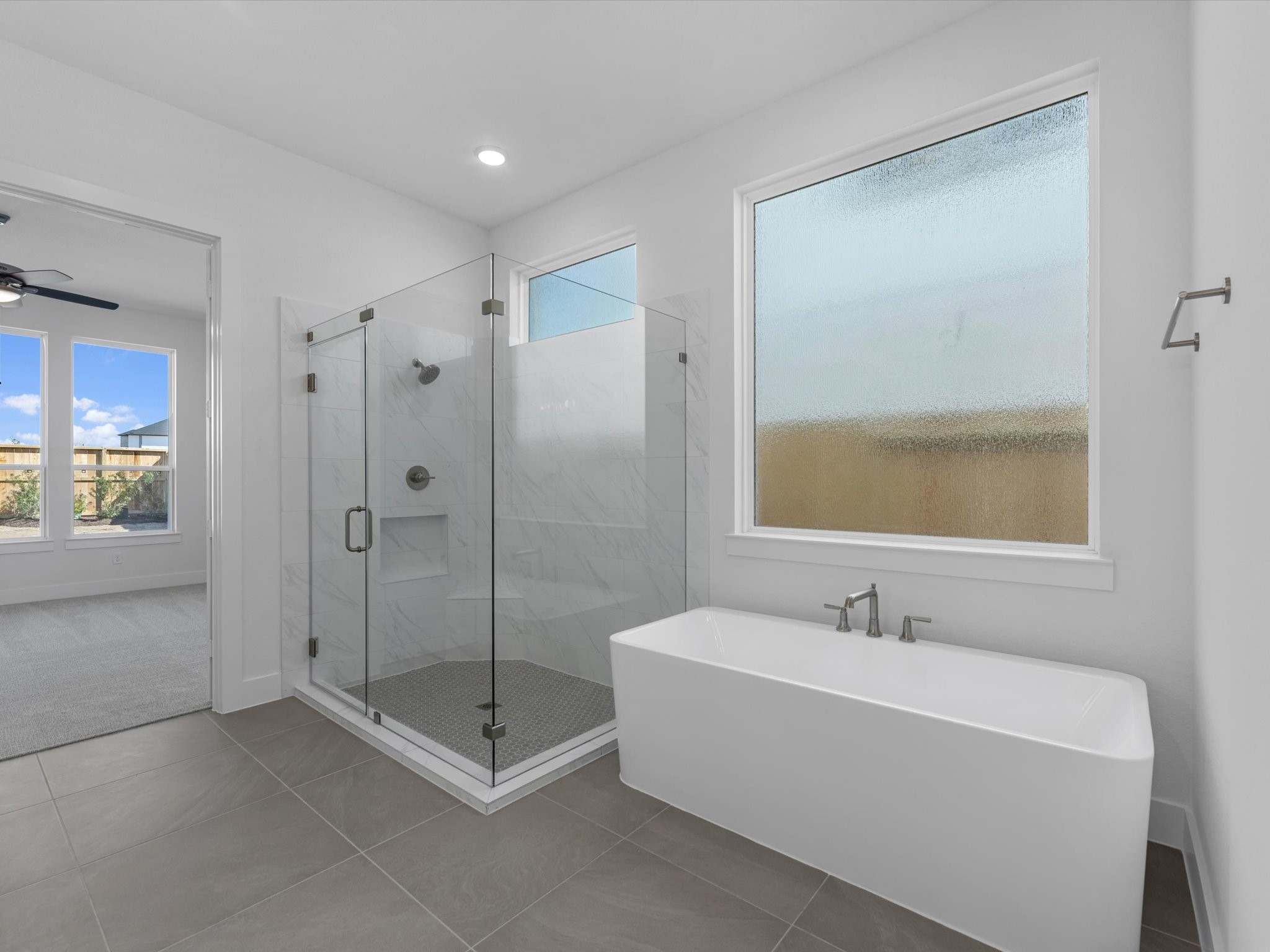 8011 Sunny Rdg Drive Fulshear, TX 77441 - Photo 13 of 32 a bathroom with a bathtub and a shower