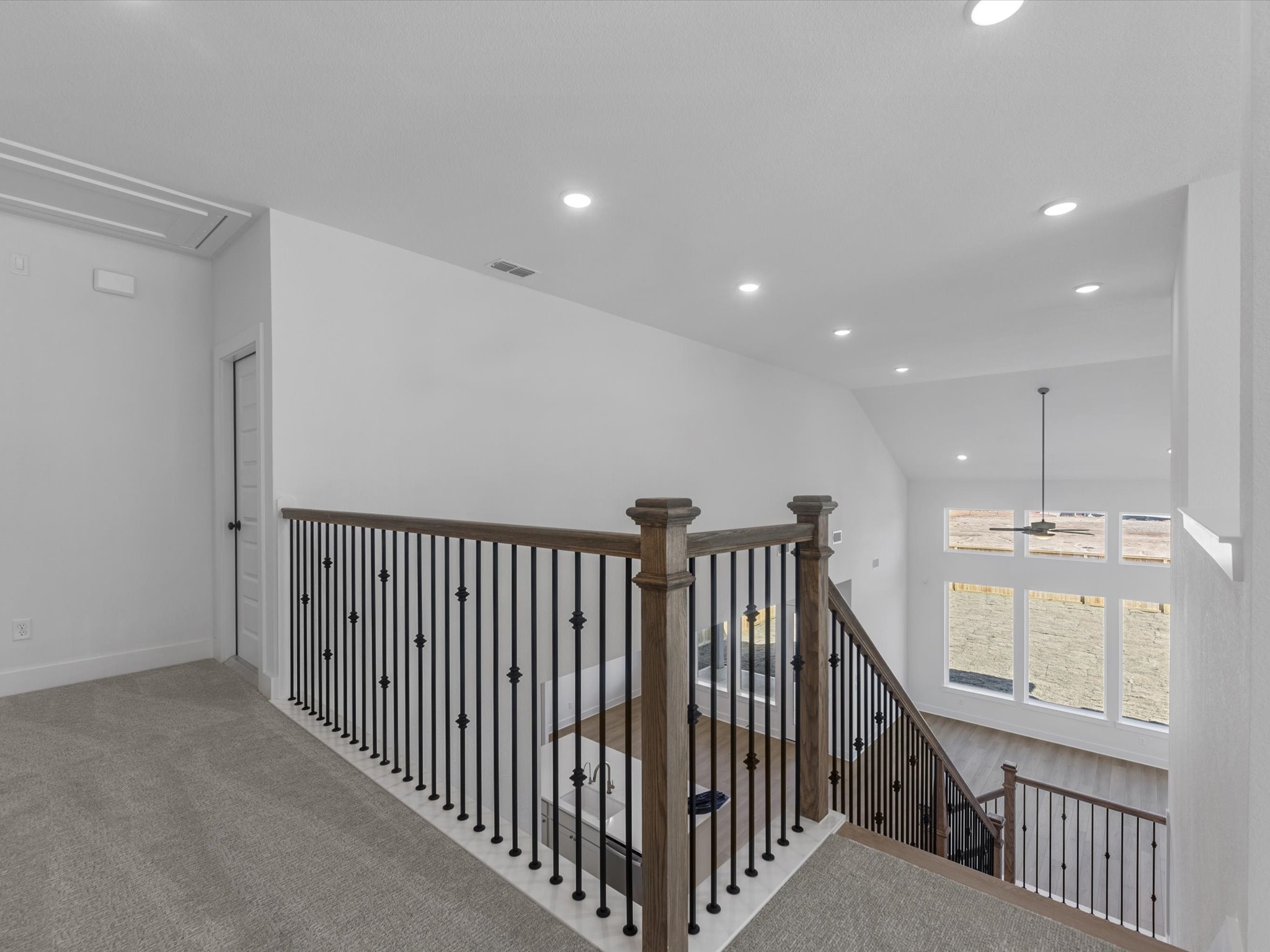 8011 Sunny Rdg Drive Fulshear, TX 77441 - Photo 16 of 32 a view of staircase with railing and a chandelier