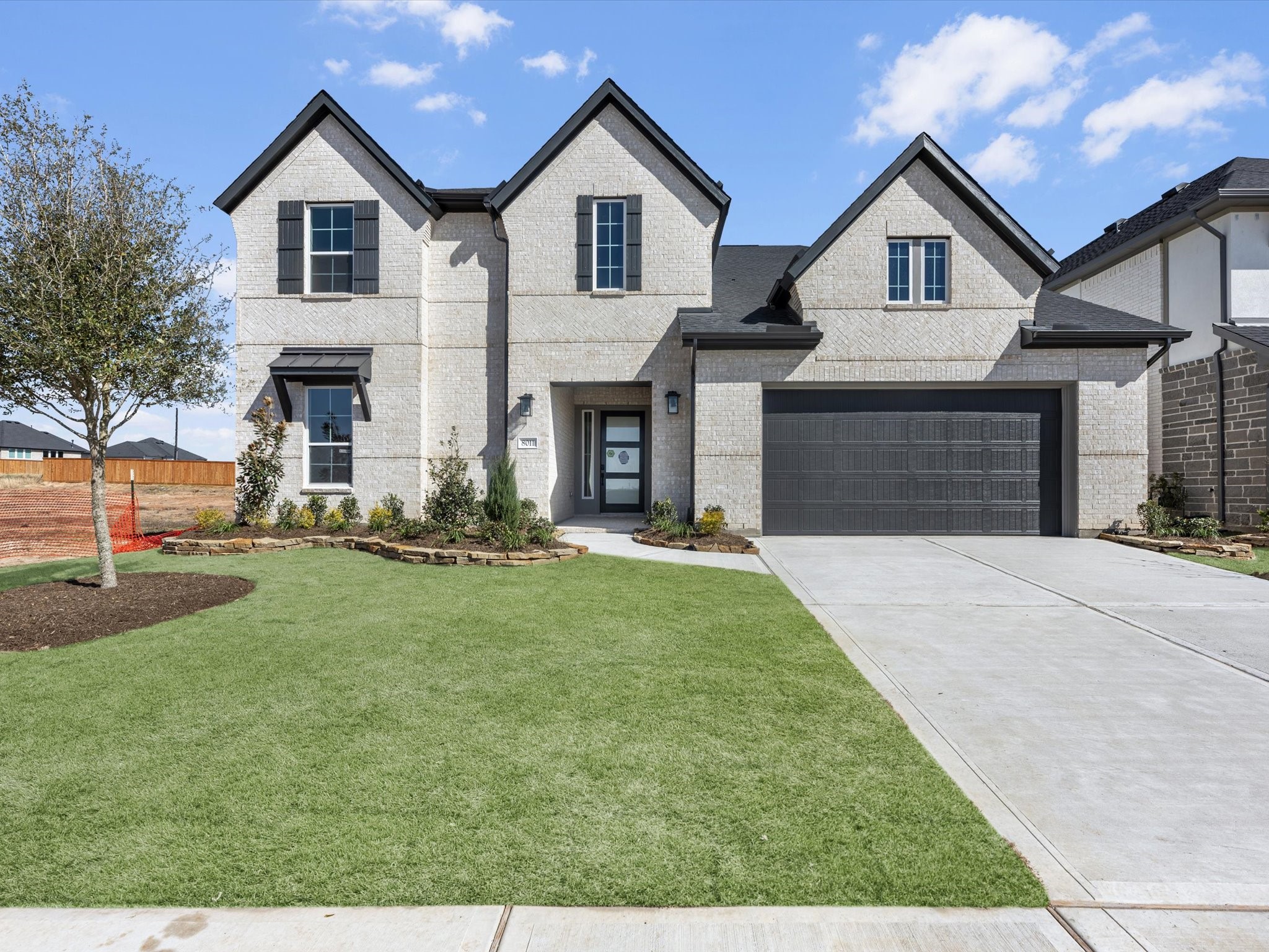 8011 Sunny Rdg Drive Fulshear, TX 77441 - Photo 23 of 32 a front view of a house with a yard and garage