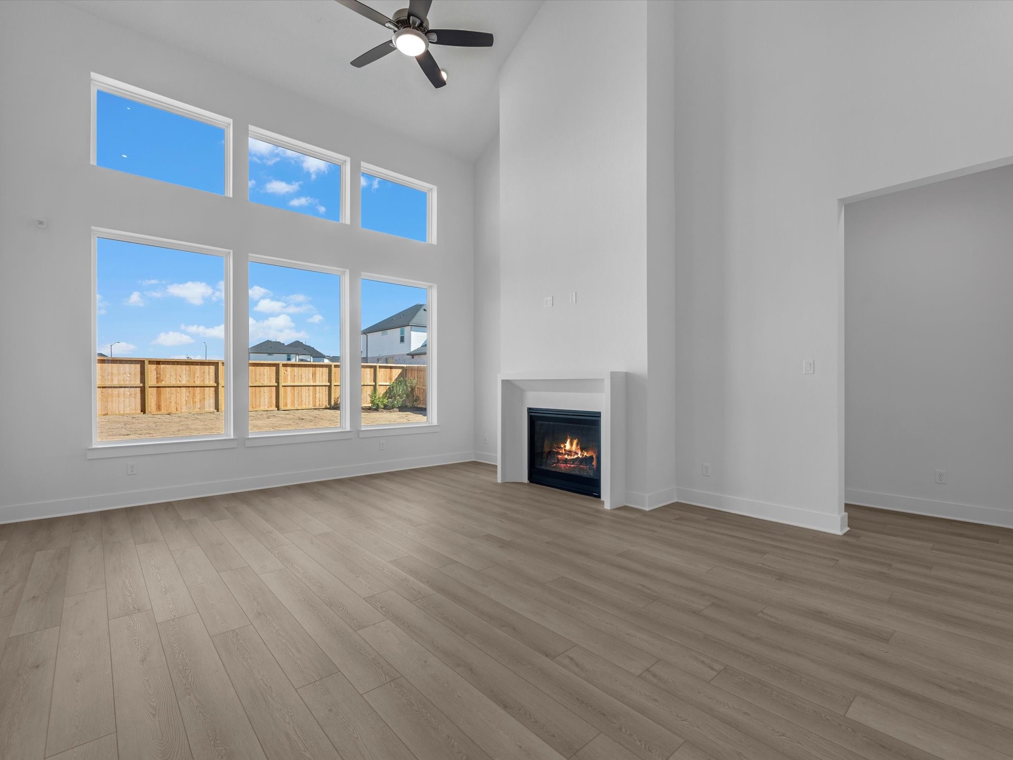 8011 Sunny Rdg Drive Fulshear, TX 77441 - Photo 8 of 32 a view of an empty room with wooden floor fireplace and a window