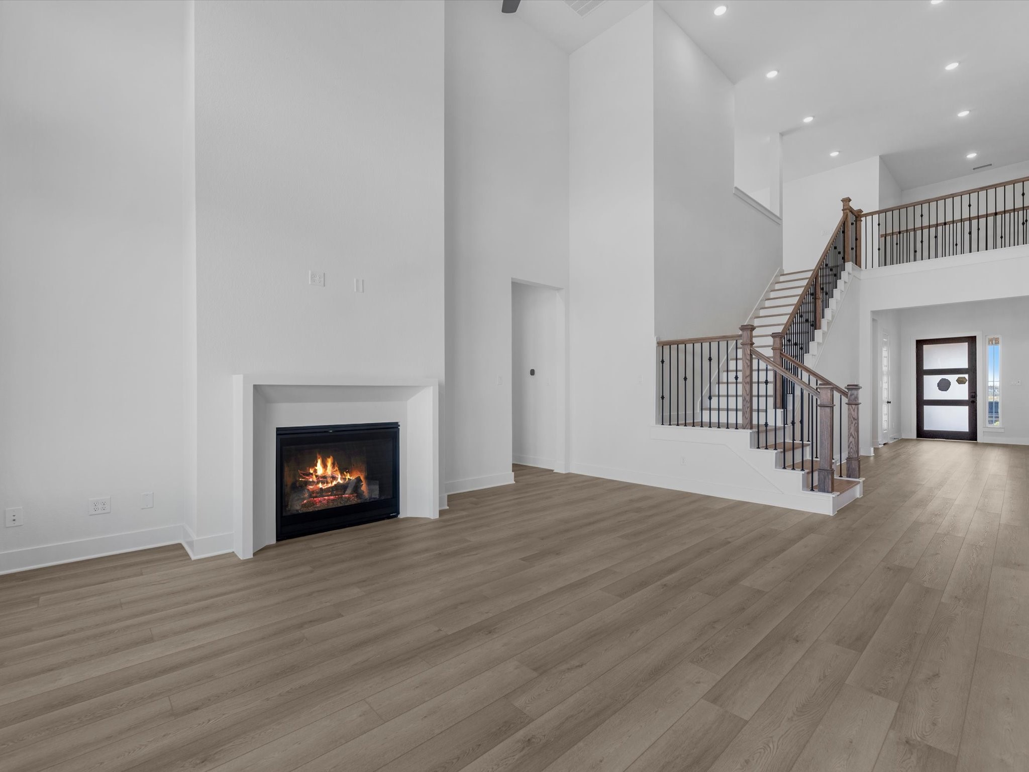 8011 Sunny Rdg Drive Fulshear, TX 77441 - Photo 10 of 32 a view of an empty room with wooden floor fire place