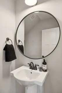 a bathroom with a sink and mirror